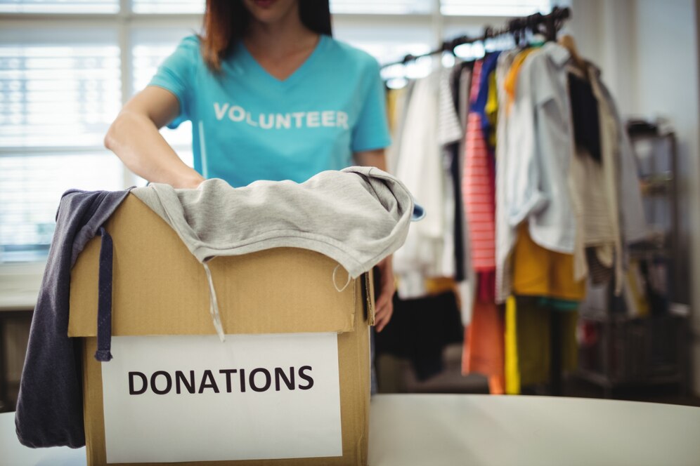 Woman packing clothes for donation